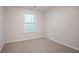 Bright bedroom with neutral walls, plush carpet, and a window letting in natural light at 2545 Davenport Park Dr, Duluth, GA 30096