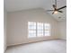 Vaulted bedroom featuring neutral walls, plush carpet, and large window at 2545 Davenport Park Dr, Duluth, GA 30096
