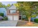 Charming two-story brick home with a two-car garage and a well-maintained front yard at 2545 Davenport Park Dr, Duluth, GA 30096