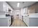Bright kitchen featuring white cabinets, stainless steel appliances, and updated countertops at 2545 Davenport Park Dr, Duluth, GA 30096