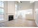 Spacious living room featuring a fireplace, tall windows, and view of kitchen at 2545 Davenport Park Dr, Duluth, GA 30096