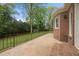 Brick home features a large patio with an iron railing, and green grass at 3188 Sunnyford Ln, Lithonia, GA 30038