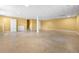 Large finished basement area with tile floors, yellow walls, and access to the upper level at 3188 Sunnyford Ln, Lithonia, GA 30038