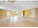 Spacious finished basement with tile floors, bright yellow walls, and multiple access doors at 3188 Sunnyford Ln, Lithonia, GA 30038