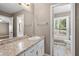 Bathroom with granite countertop, white cabinetry, and a toilet with a window at 3188 Sunnyford Ln, Lithonia, GA 30038