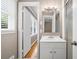 Bathroom features a vanity with storage, a tiled shower, and a window at 3188 Sunnyford Ln, Lithonia, GA 30038