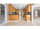 Efficient kitchen layout with ample cabinet space, tile flooring, and an open view to another room at 3188 Sunnyford Ln, Lithonia, GA 30038