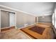 Bright living room showcasing multi-tone flooring, neutral walls, and access to the kitchen at 3188 Sunnyford Ln, Lithonia, GA 30038