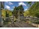 Back deck with trees and blue sky visible from worn wooden plank flooring at 507 Matthew Dr, Canton, GA 30115