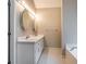 Bright bathroom featuring a double vanity, oval mirrors, and tile flooring at 507 Matthew Dr, Canton, GA 30115