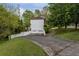 View of the home's driveway and two-car garage and freshly cut green lawn at 507 Matthew Dr, Canton, GA 30115