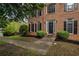 Close-up of a classic brick home with a welcoming front entrance and manicured landscaping at 507 Matthew Dr, Canton, GA 30115