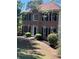 Classic brick home featuring a symmetrical facade, a well-manicured lawn, and lush landscaping at 507 Matthew Dr, Canton, GA 30115