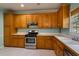 Bright kitchen with wood cabinets, stainless steel oven and sink, and white laminate countertops at 507 Matthew Dr, Canton, GA 30115