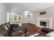 Cozy living room with hardwood floors, fireplace, and views to the sunroom at 507 Matthew Dr, Canton, GA 30115