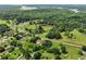 Scenic aerial view featuring a blend of verdant forests, scattered houses, and a distant body of water at 5711 Parks Rd, Cumming, GA 30041