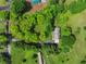 Aerial view of a property with lush greenery surrounding a house, showcasing a serene and private setting at 5711 Parks Rd, Cumming, GA 30041