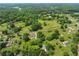 Expansive aerial view of a lush, green landscape dotted with homes, fields, and waterways at 5711 Parks Rd, Cumming, GA 30041