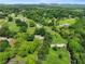 Sprawling property with lush greenery, featuring a charming home, barn, and surrounded by mature trees and open fields at 5711 Parks Rd, Cumming, GA 30041