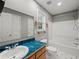 This hall bathroom features a single vanity and a shower-tub combo at 5711 Parks Rd, Cumming, GA 30041