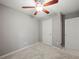 A cozy bedroom with neutral paint, soft carpeting, and a ceiling fan with lighting at 5711 Parks Rd, Cumming, GA 30041