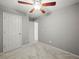 Neutral bedroom featuring a lighted ceiling fan, and plush carpet at 5711 Parks Rd, Cumming, GA 30041