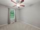 This bedroom features neutral walls, plush carpet, and a ceiling fan at 5711 Parks Rd, Cumming, GA 30041