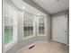 Bright entryway with tile flooring, and multiple windows letting in natural light, and a door to the exterior at 5711 Parks Rd, Cumming, GA 30041