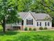 Charming home with a classic design, featuring a welcoming front porch, well-manicured lawn, and mature shade trees at 5711 Parks Rd, Cumming, GA 30041