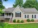 Charming home featuring a landscaped front yard, classic shutters, and a welcoming front porch at 5711 Parks Rd, Cumming, GA 30041