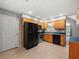Cozy kitchen features wood cabinets, stainless steel appliances, tile flooring, and bright windows at 5711 Parks Rd, Cumming, GA 30041