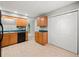 Cozy kitchen features wood cabinets, stainless steel appliances, tile flooring, and bright windows at 5711 Parks Rd, Cumming, GA 30041