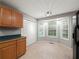 Cozy kitchen features wood cabinets, stainless steel appliances, tile flooring, and bright windows at 5711 Parks Rd, Cumming, GA 30041