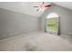 Bright living room featuring neutral walls, vaulted ceiling, ceiling fan, and large window with abundant natural light at 5711 Parks Rd, Cumming, GA 30041