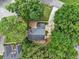 Aerial view of home surrounded by mature trees, well manicured lawn and paved driveway at 6815 Fairgreen Dr, Suwanee, GA 30024
