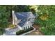 Aerial view of the home with mature trees, an attached garage, and backyard at 6815 Fairgreen Dr, Suwanee, GA 30024