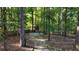 Large backyard features mature trees and a fenced in play area with a play set at 6815 Fairgreen Dr, Suwanee, GA 30024