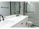 Close up of the bathroom with a double vanity, a large mirror, and glass enclosed shower with attractive tile work at 6815 Fairgreen Dr, Suwanee, GA 30024