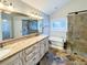 A well-lit bathroom features double sinks, granite countertops, and a walk-in shower at 6815 Fairgreen Dr, Suwanee, GA 30024