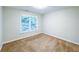 This bedroom features neutral walls, cozy brown carpeting and a bright window with white blinds at 6815 Fairgreen Dr, Suwanee, GA 30024