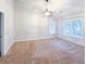 An airy bedroom with neutral carpet, a ceiling fan, and bright windows at 6815 Fairgreen Dr, Suwanee, GA 30024