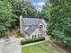 Charming two-story home with well-maintained landscaping and a basketball hoop out front at 6815 Fairgreen Dr, Suwanee, GA 30024