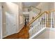 Two story foyer featuring hardwood floors, a stairway, and natural light at 6815 Fairgreen Dr, Suwanee, GA 30024