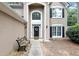 Stunning front entrance with a grand archway and manicured landscape at 6815 Fairgreen Dr, Suwanee, GA 30024
