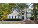 View of front exterior with a manicured lawn, a bench, and a landscaped yard at 6815 Fairgreen Dr, Suwanee, GA 30024