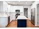 Modern kitchen with white cabinets, a center island, and stainless steel appliances at 6815 Fairgreen Dr, Suwanee, GA 30024