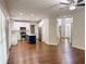 A spacious living room with hardwood floors leading to the kitchen and foyer at 6815 Fairgreen Dr, Suwanee, GA 30024