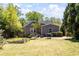 Well-maintained backyard with patio, grill, raised garden beds, and mature trees, great for outdoor living at 812 E Ponce De Leon Ave, Decatur, GA 30030