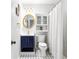 Bright bathroom featuring a navy blue vanity, gold accents, and black and white tile floor at 812 E Ponce De Leon Ave, Decatur, GA 30030