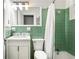 Retro bathroom with green tile, a shower-tub combination, and a modern vanity at 812 E Ponce De Leon Ave, Decatur, GA 30030